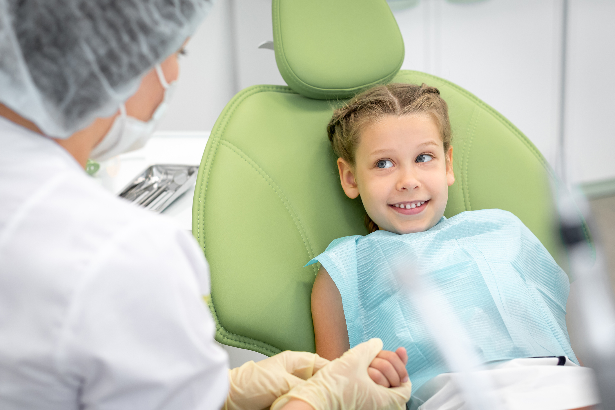 Happy caucasian kid on regular check up of teeth in dental clinic
